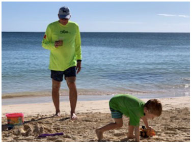 A little boy and his grandpa at the beach